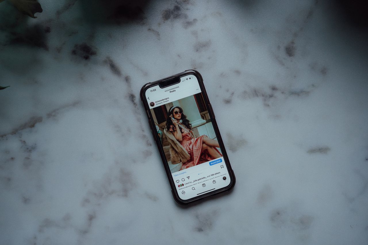 Services-02 A smartphone showing an Instagram post against a marble background, showcasing modern social media use.